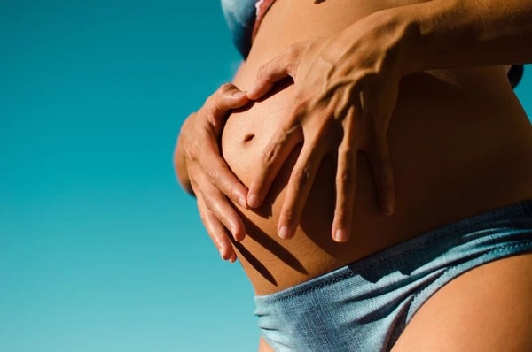 pregnant woman holding her belly