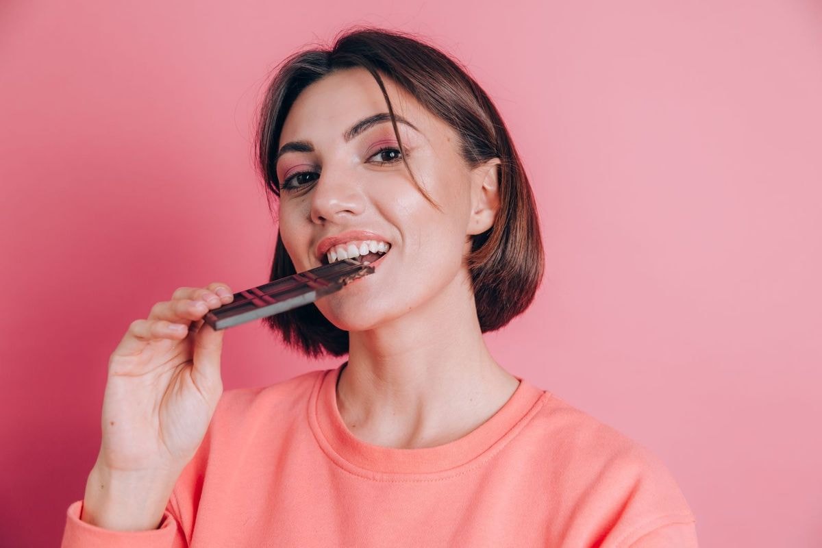 Woman Eating Dark Chocolate