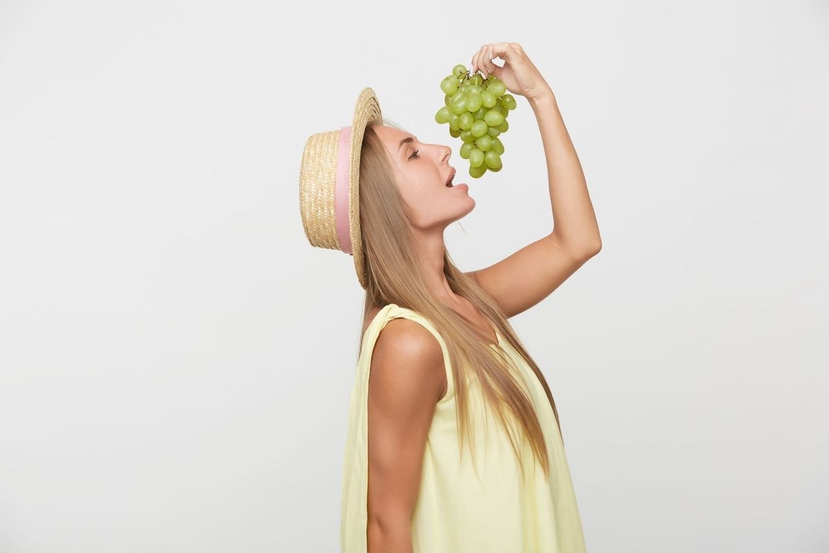 Woman Eating Grapes