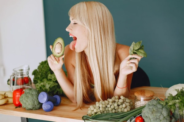 woman posing with vegetables