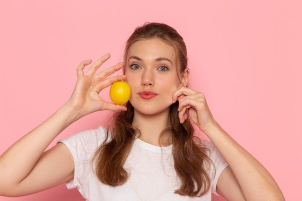 woman holding lemon